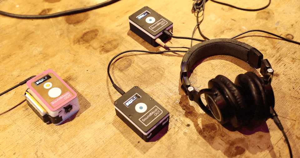 Hands operating the SoundMesh prototype.
